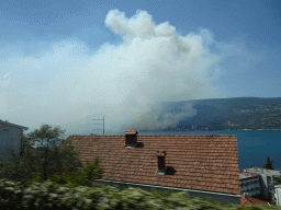 The Bay of Kotor and smoke from a forest fire near the town of Njivice, viewed from the tour bus on the E65 road at the town of Herceg Novi