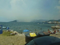 The Zmijica Beach at the town of Zelenika and smoke from a forest fire near the town of Njivice, viewed from the tour bus on the E65 road