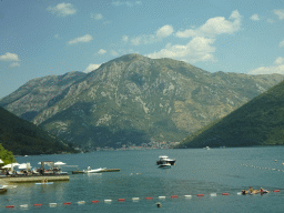 Boats at the Bay of Kotor, beach at the town of Kamenari and the town of Perast, viewed from the tour bus on the E65 road