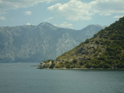 The Bay of Kotor and the Church of Our Lady of Angels at the town of Lepetani, viewed from the tour bus on the E65 road just north of the town of Kamenari