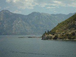 The Bay of Kotor and the Church of Our Lady of Angels at the town of Lepetani, viewed from the tour bus on the E65 road just north of the town of Kamenari