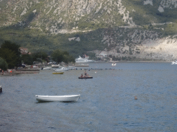 Boats at the Bay of Kotor and beach at the town of Kostanjica, viewed from the tour bus on the E65 road
