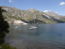 Boats at the Bay of Kotor and the town of Lipci, viewed from the tour bus on the E65 road at the town of Kostanjica