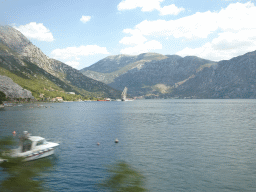 Boat at the Bay of Kotor and the towns of Lipci and Risan, viewed from the tour bus on the E65 road