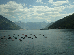 Boat at the Bay of Kotor with the Our Lady of the Rocks Island and the Saint George Island and the town of Perast, viewed from the tour bus on the E65 road at the town of Morinj