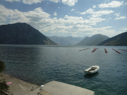 Boat at the Bay of Kotor with the Our Lady of the Rocks Island and the Saint George Island and the town of Perast, viewed from the tour bus on the E65 road at the town of Lipci