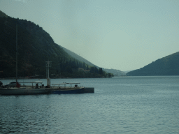 Boats at the Risan Harbour and the Bay of Kotor with the Our Lady of the Rocks Island and the Saint George Island, viewed from the tour bus on the E65 road