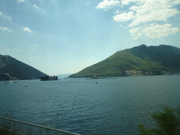 The Bay of Kotor with the Our Lady of the Rocks Island and the Saint George Island and the town of Kostanjica, viewed from the tour bus on the E65 road just northwest of the town of Perast