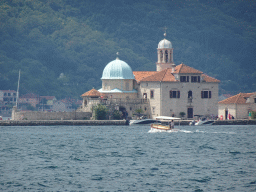 Boats in front of the Our Lady of the Rocks Island at the Bay of Kotor, viewed from the Perast Harbour