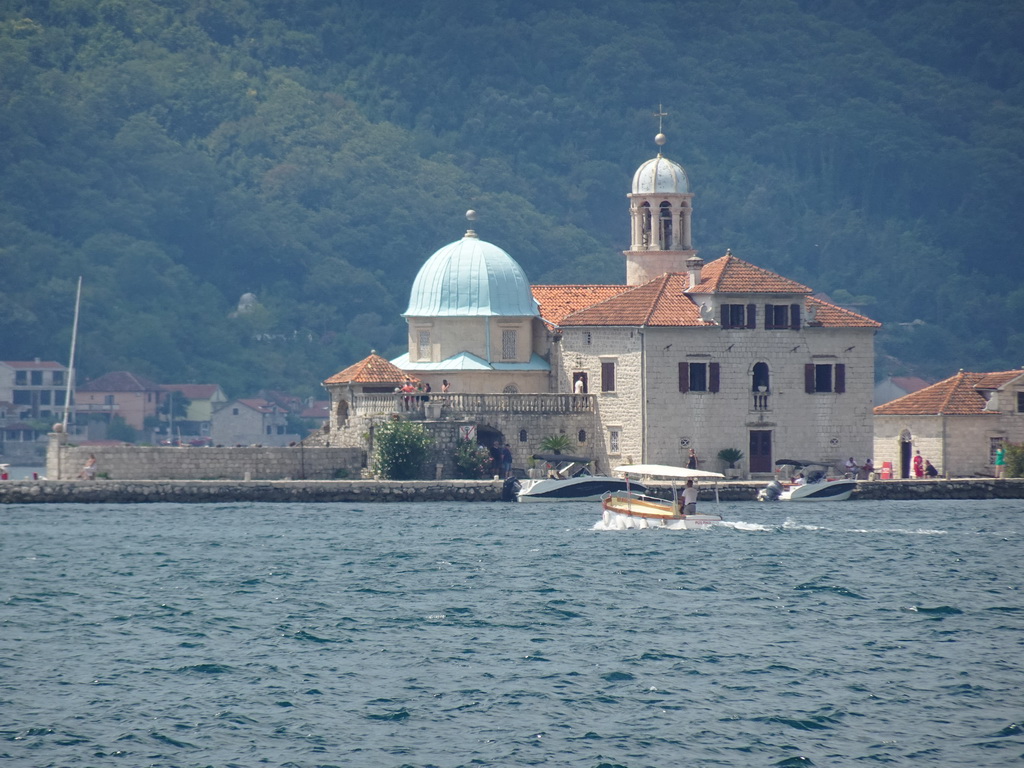 Boats in front of the Our Lady of the Rocks Island at the Bay of Kotor, viewed from the Perast Harbour