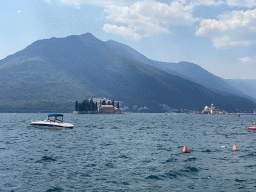 Boats the Bay of Kotor with the Our Lady of the Rocks Island and the Saint George Island and the town of Kostanjica, viewed from the Perast Harbour