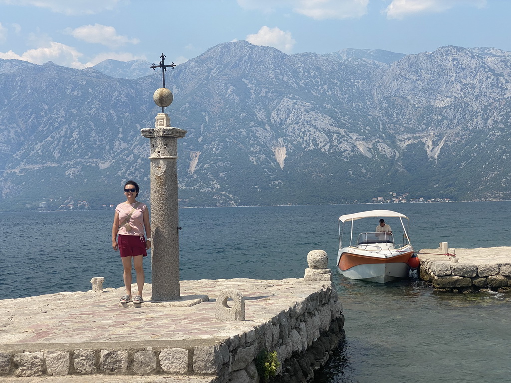 Miaomiao with a pillar and a boat at the northwest side of the Our Lady of the Rocks Island