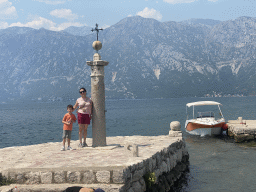 Miaomiao and Max with a pillar and a boat at the northwest side of the Our Lady of the Rocks Island