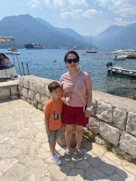 Miaomiao and Max at the Perast Harbour, with a view on the Bay of Kotor with the Our Lady of the Rocks Island and the Saint George Island