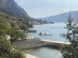 The Bay of Kotor and houses and oyster farm at the town of Ljuta, viewed from the tour bus on the E65 road
