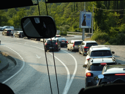 Cars waiting in line for the Montenegro-Croatia border crossing near the town of Sutorina, viewed from the tour bus on the E65 road