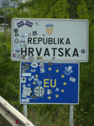 Croatia and European union signs at the Montenegro-Croatia border crossing near the town of Sutorina, viewed from the tour bus on the E65 road