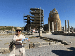 Miaomiao with a reconstruction in a travel guide in front of the Hellenistic City Gate and Towers at the Ancient City of Perge, under renovation
