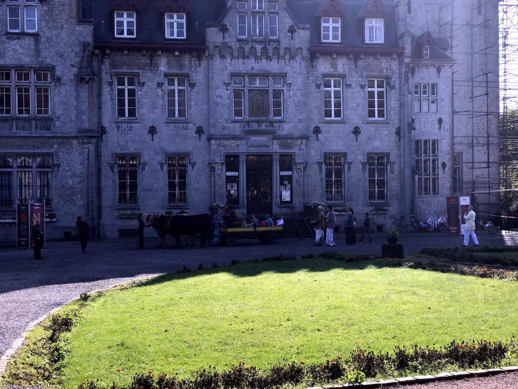 Cows and wagon with ISKCON community members in front of the Castle of Petite-Somme