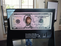 Miaomiao in a giant 5 dollar bill in the Independence Visitor Center