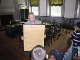 Tour guide with a copy of the Declaration of Independence, in the Assembly Room of Independence Hall