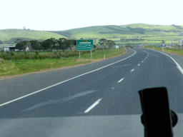 The Bass Highway and hills with grasslands, viewed from our tour bus