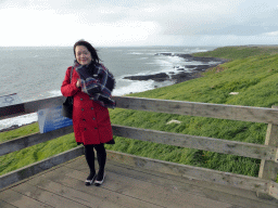 Miaomiao at the Nobbies Boardwalk, with a view on the cliffs at the Bass Strait