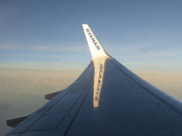 The left wing of our Ryanair airplane, with a view on the Alps mountains