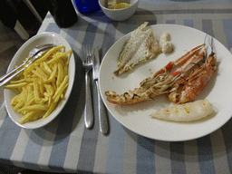 Fries, fish and seafood at the La Buca restaurant at the Via Massimo D`Azeglio street