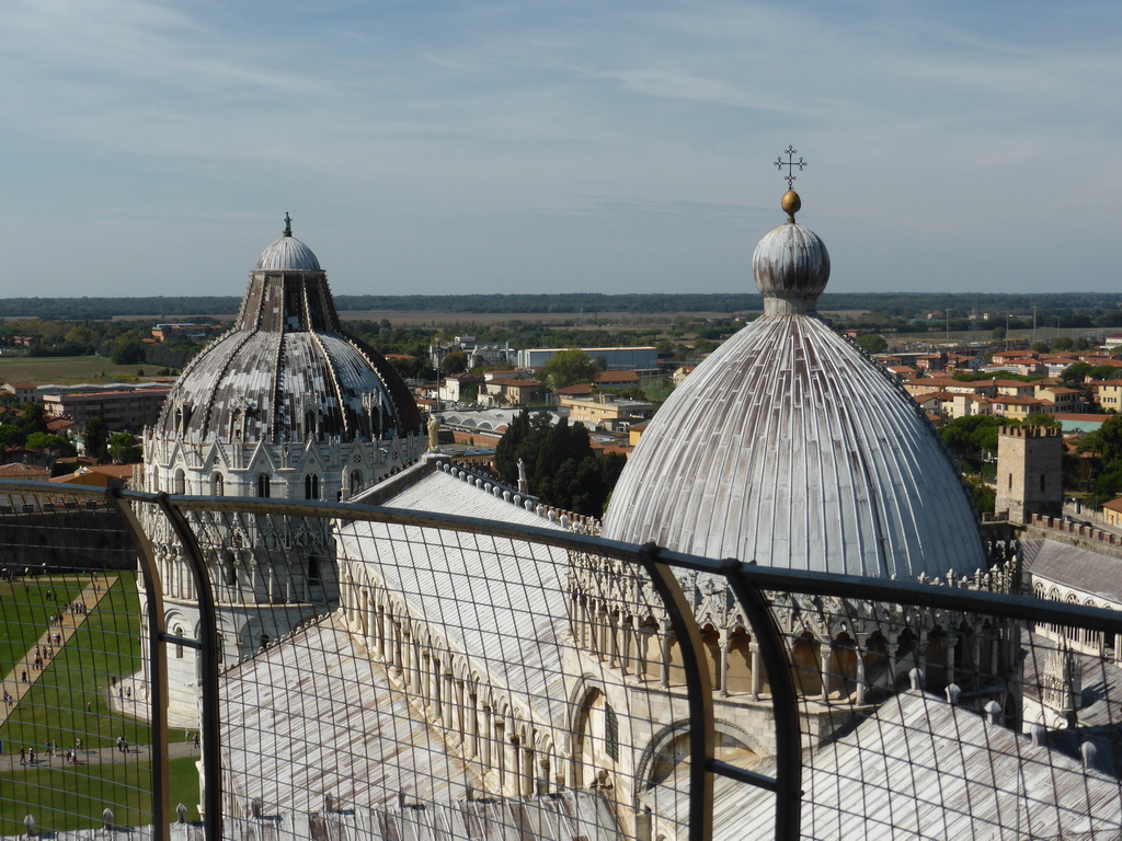 The top floor of the Leaning Tower of Pisa and a view on the Piazza del Duomo square with the Pisa Duomo cathedral, the Baptistry of St. John, the City Wall and the west side of the city