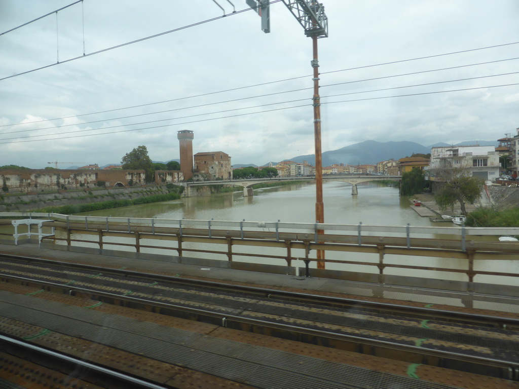 The Ponte della Cittadella bridge over the Arno river and the Cittadella Vecchia citadel with the Torre Guelfa tower, viewed from the train from Levanto