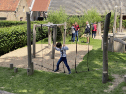 Max on a rope bridge at the playground at the main square at Loevestein Castle