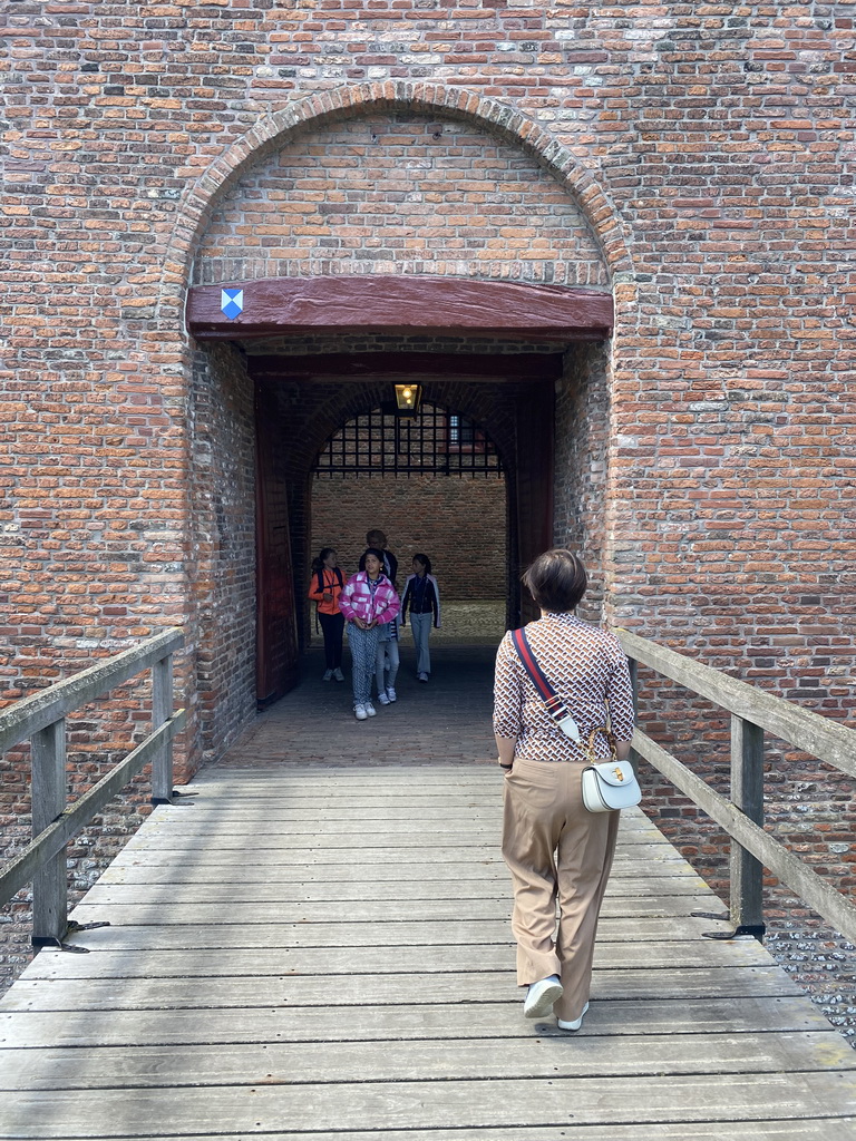 Miaomiao walking over the bridge at the southeast side of Loevestein Castle