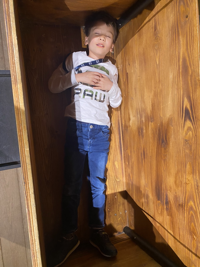 Max in a book chest at the 400 Years Hugo de Groot exhibition at the Middle Floor of Loevestein Castle