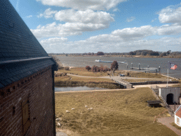 The entrance at the north side of Loevestein Castle and boat on the Waal river, viewed from the Top Floor
