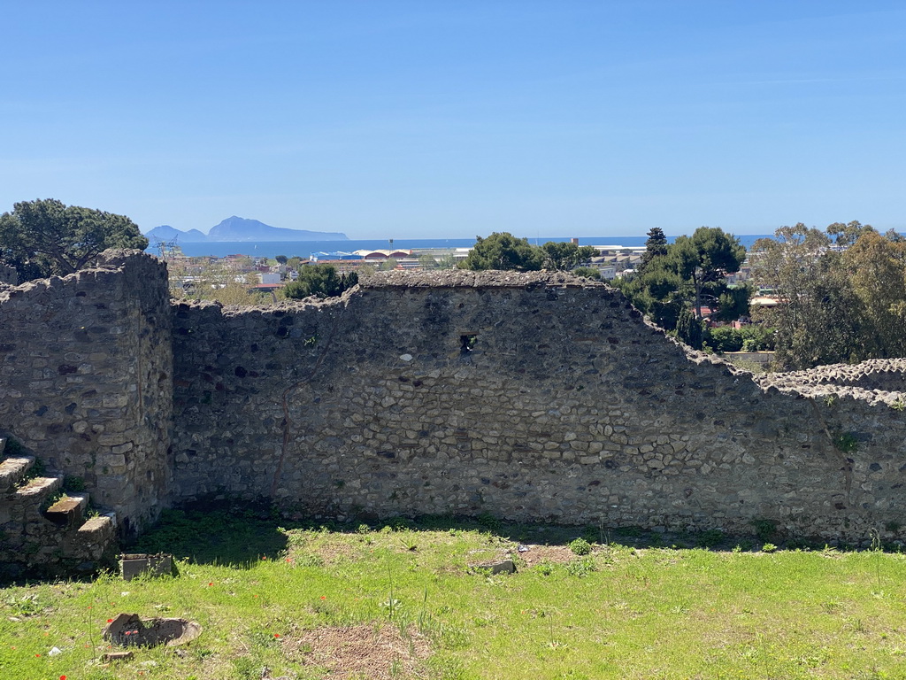 Walls at the House of the Sailor at the Pompeii Archeological Site, with a view on the Tyrrhenian Sea and the island of Capri
