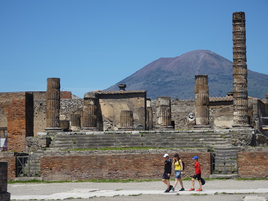 Walls and columns at the Temple of Jupyter at the Forum at the Pompeii Archeological Site, with a view on Mount Vesuvius