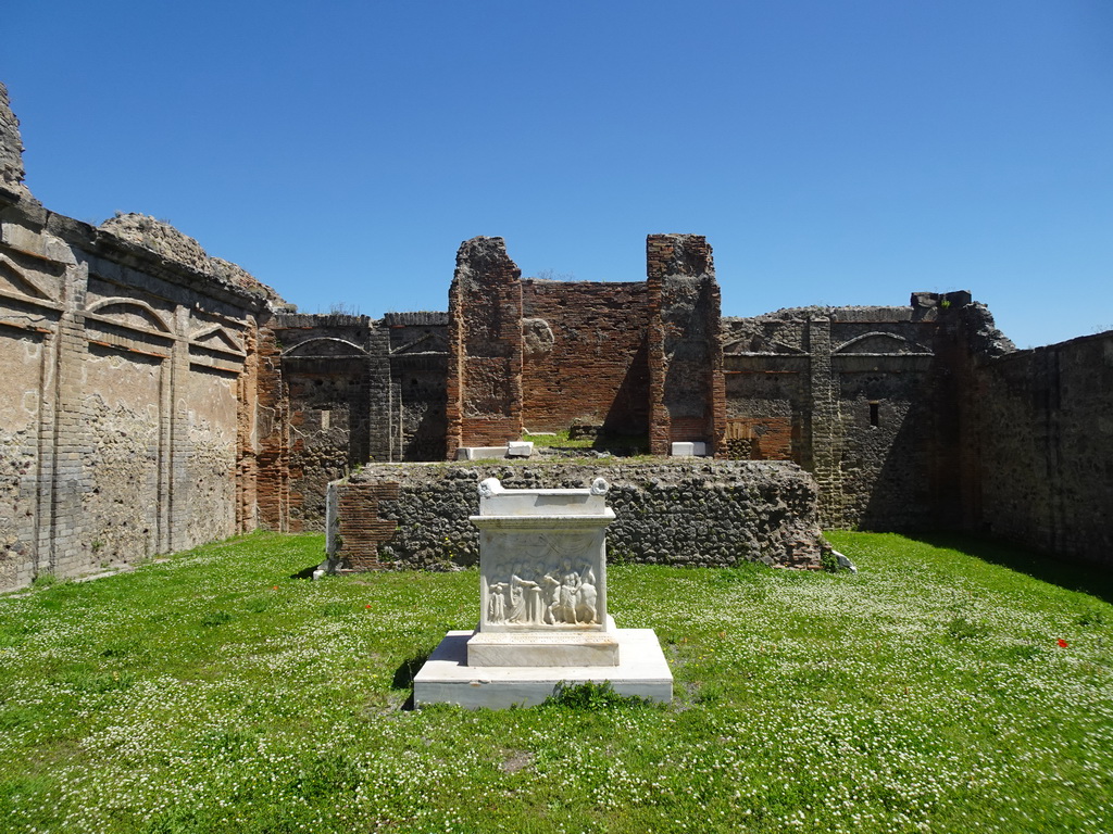 Marble altar with frieze and walls at the Temple of Vespasian at the Pompeii Archeological Site, viewed from the Forum