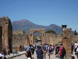 Gate over the Via di Mercurio street and the Torre XI tower at the Pompeii Archeological Site, with a view on Mount Vesuvius