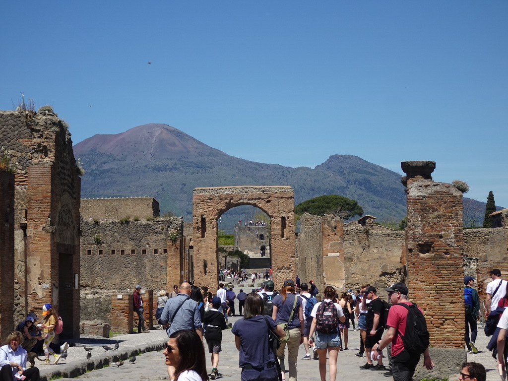 Gate over the Via di Mercurio street and the Torre XI tower at the Pompeii Archeological Site, with a view on Mount Vesuvius