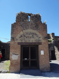 Door at the front of the Forum Baths at the Via di Mercurio street at the Pompeii Archeological Site, with explanation