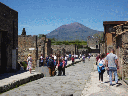 The Via di Mercurio street and the Torre XI tower at the Pompeii Archeological Site, with a view on Mount Vesuvius