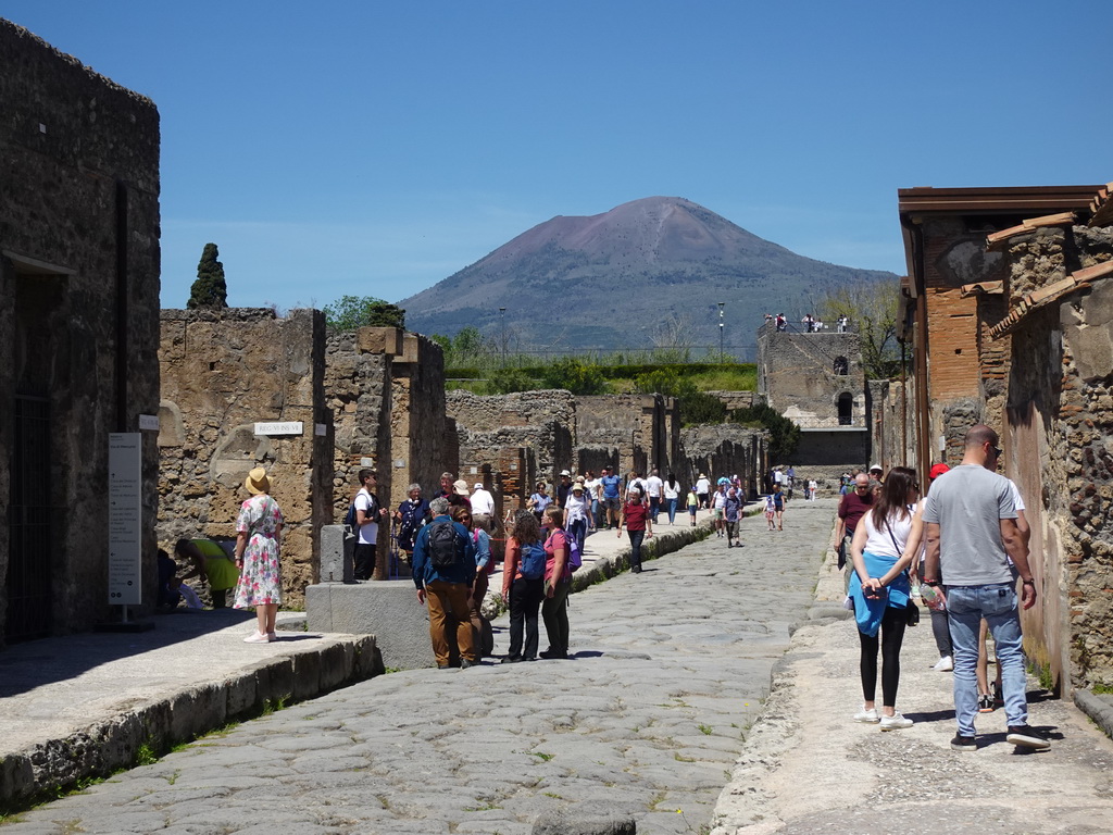 The Via di Mercurio street and the Torre XI tower at the Pompeii Archeological Site, with a view on Mount Vesuvius