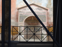 Fountain with mosaics at the House of the Small Fountain at the Pompeii Archeological Site, viewed from the Via di Mercurio street