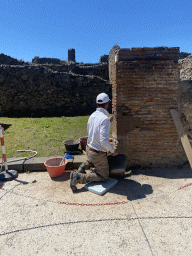 Mason renovating a wall at the Via di Mercurio street at the Pompeii Archeological Site