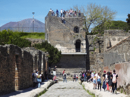 The Via di Mercurio street and the Torre XI tower at the Pompeii Archeological Site, with a view on Mount Vesuvius