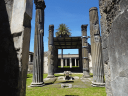Altar and columns at the House of the Labyrinth at the Pompeii Archeological Site, viewed from the Vicolo di Mercurio street