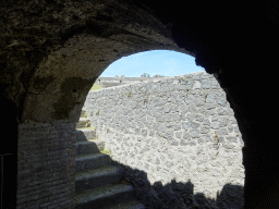 Grandstands and wall at the Amphitheatre at the Pompeii Archeological Site, viewed from a gate at the southwest catacombs