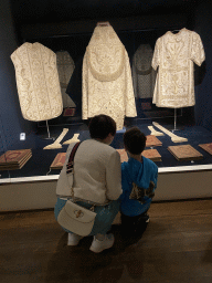 Miaomiao and Max with priest gowns and books at the Treasury of the Porto Cathedral