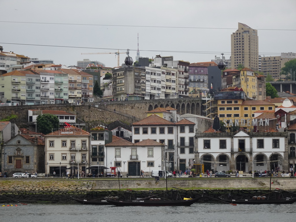 Boats on the Douro river and Vila Nova de Gaia with the Gaia Cable Car, viewed from the Cais da Estiva street